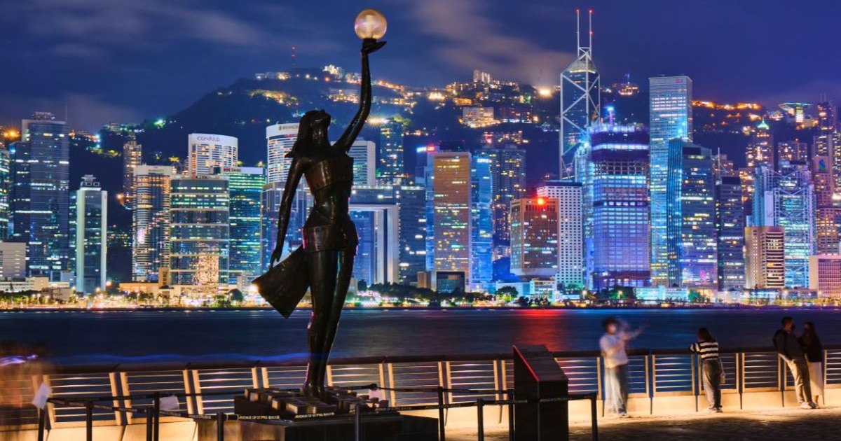 Avenue of Stars with the Hong Kong Film Award’s statue tribute against the glittering Victoria Harbour at night