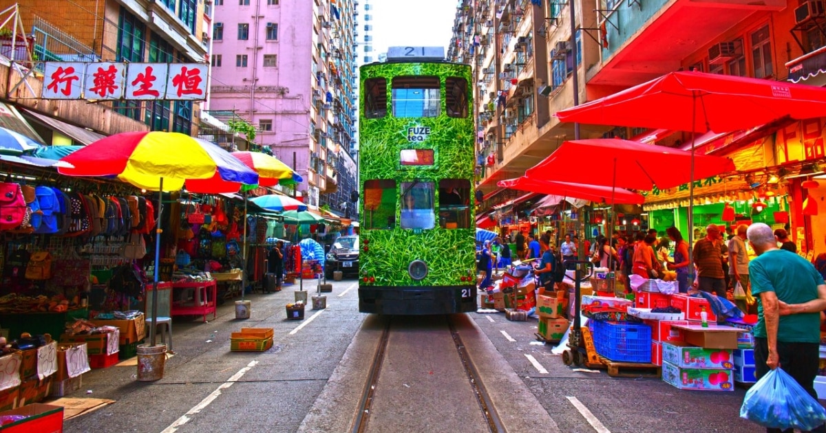 A green tram travels through the Chun Yeung Street wet market in North Point